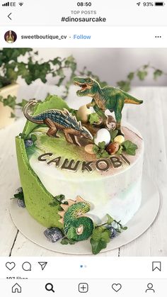an image of a cake decorated with dinosaurs on the top and words that spell out i love you