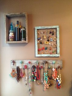 a wall mounted jewelry rack with earrings and necklaces on it