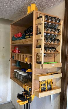 a workbench with tools and other items on the shelf in front of it