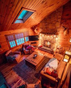 a living room filled with furniture and a fire place in the middle of a loft