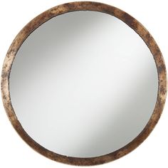 a round wooden mirror hanging on the wall in front of a white background with an old wood frame