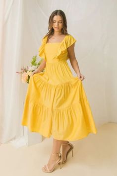 Yellow Maxi Dress - Bella Chic Fashion Boutique A solid women midi dress featuring square neckline with ruffle at side, tiered skirt, open back tie bow. Details: Self: 50% Polyester 50% Rayon Lining: 100% Polyester Size & Fit - Model is 5'8" And Wearing Size Small - Measurements Taken From Size Small - Approx. Length: 45.5" Yellow Bohemian Dress, Citron Dress, Bridesmade Dresses, Dress Paris, Yellow Sundress, Yellow Maxi Dress, Aesthetic Dress, Yellow Maxi, Yellow Floral Dress