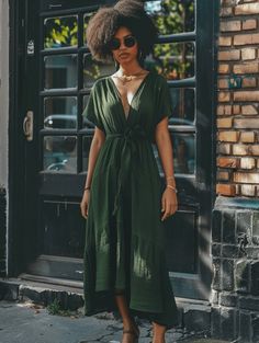 This olive green maxi dress is a tribute to the contemporary urban spirit. Its V-neck and front tie accentuate the waist, while the mid-length sleeves offer a balance between modesty and allure. The textured fabric and the midi length make it an excellent choice for a day of city exploration or a casual workday. Accessorized with simple black flats and sunnies, this dress is a nod to the chic comfort required to navigate the bustling streets in style. Olive Green Maxi Dress, Green Maxi Dress