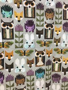 a quilt with many different types of animals on it's sides and one has an owl in the middle