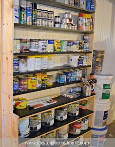 the shelves are full of paint and other items