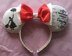 a minnie mouse headband with a red bow