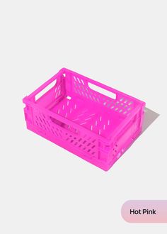 a pink plastic basket sitting on top of a white surface with the words hot pink