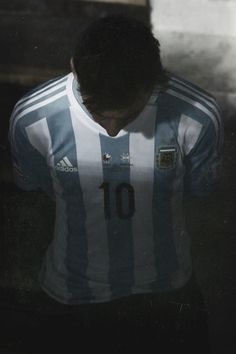 a soccer player is looking down at the ground