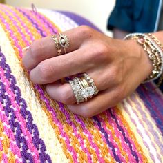 a close up of a person's hand with rings on it