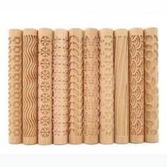 a row of carved wooden dowels on a white background