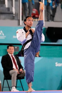 a woman standing on top of a blue mat