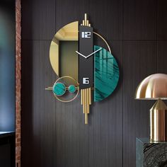 a clock that is on the side of a wall next to a table and lamp