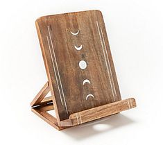 a wooden object with three phases on it