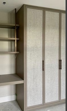 an empty closet with shelves and shelving unit in the corner, next to a white wall