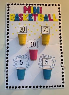 a bulletin board with three cups on it and the numbers 5 to 10 in front of them