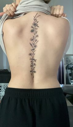 the back of a woman's lower back tattoo