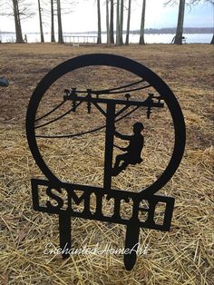 a metal sculpture sitting on top of dry grass