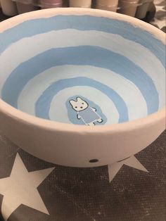 a blue and white bowl with a sticker on it's side sitting on a table