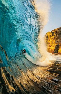 a man riding a wave on top of a surfboard