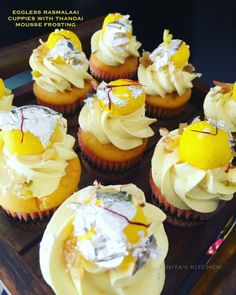 cupcakes with lemon and white frosting on a tray