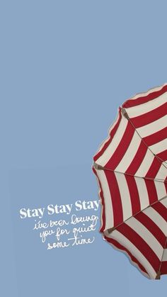 a red and white striped umbrella with the words stay strong on it's side