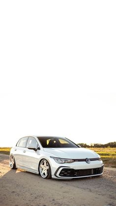 a white car parked on the side of a road