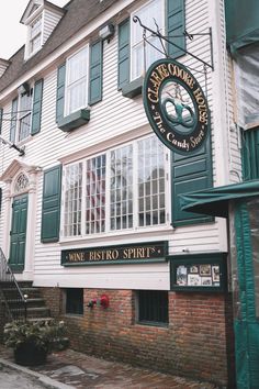 an old building with green shutters on the front and side windows that says wine bistro spirit's