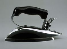 a black and silver iron on a gray background
