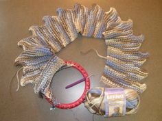 the yarn is being used to make a wreath