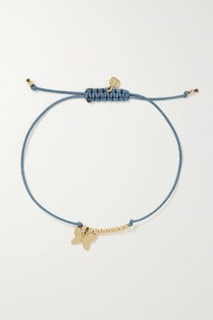 a blue cord bracelet with two gold charms and a butterfly charm on the end of it