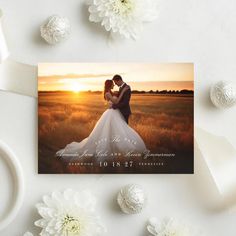 an image of a couple on their wedding day with the sun setting in the background