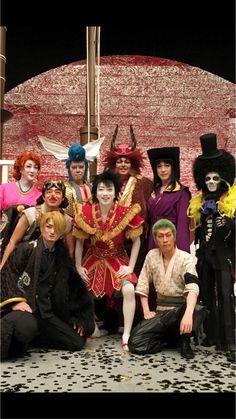 a group of people dressed in costumes posing for a photo