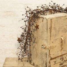 an old wooden box with branches and stars on it