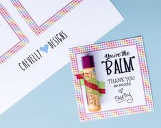 two personalized thank you notes and a bottle of lip balm on a blue background