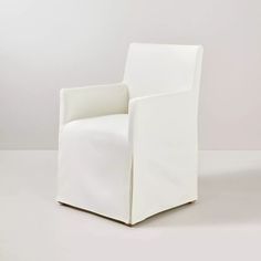 a white chair sitting on top of a white floor