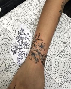 a woman's foot with a flower tattoo on it