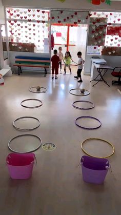 children are playing with hoop tosses in the room