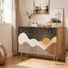 a sideboard with an art deco design on it in a living room next to a window