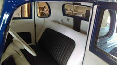 the interior of an old car with black and white seats