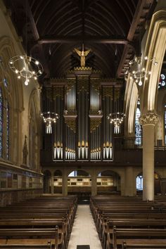 an empty church with pews and chandeliers