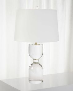 a white lamp sitting on top of a table