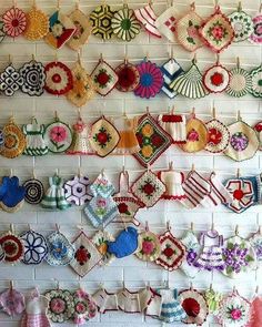 there are many crocheted items hanging on the wall