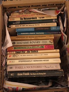 a cardboard box filled with lots of books