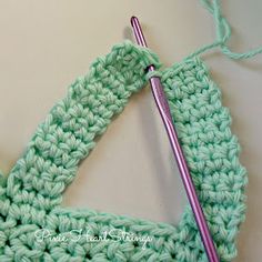 the crochet triangle is being worked on