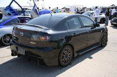 a black car parked in front of other cars