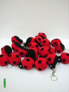 red and black crocheted ladybug key fobs on white background