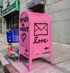 a pink mailbox with writing on it