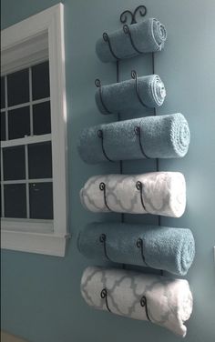 towels are hanging on the wall in front of a window and an amazon gift card has been placed next to it