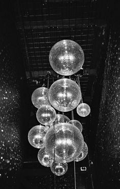 a bunch of glass balls hanging from the ceiling