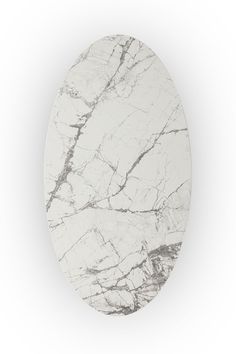 an oval white marble table top with grey veining on the edges and black accents